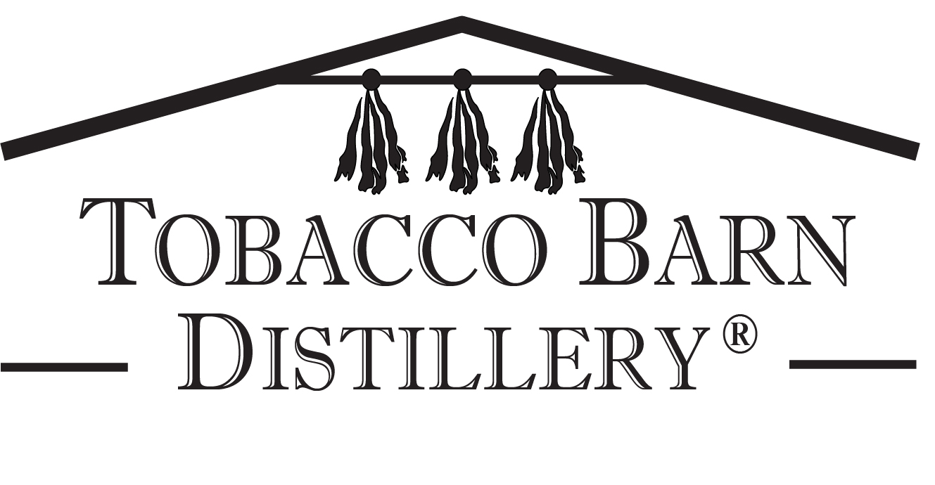 Logo for Tobacco Barn Distillery with black text and a stylized roof above, featuring three hanging tobacco leaves.